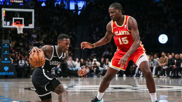 Mar 2, 2024; Brooklyn, New York, USA; Brooklyn Nets guard Dennis Schroder (17) controls the ball as Atlanta Hawks center Clint Capela (15) defends in the fourth quarter at Barclays Center. Mandatory Credit: Wendell Cruz-USA TODAY Sports